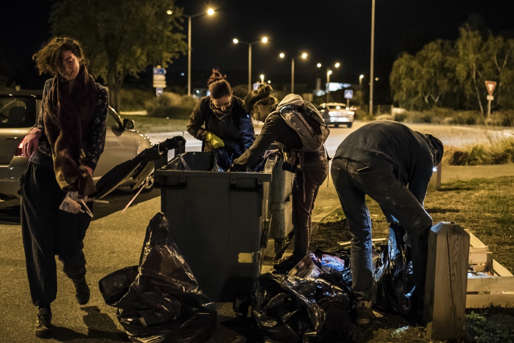 FRANCE-DISTRIBUTION-FOOD-WASTE-GASTRONOMY-POVERTY Members of the movement 'Les Gars'Pilleurs' collect food from waste containers of a supermarket in the south of Lyon, France on late September 24, 2015.