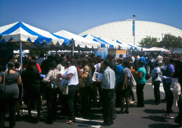 Job seekers crowd the Delta Airlines and BNSF tables in parking lot at Crenshaw Christian Center.