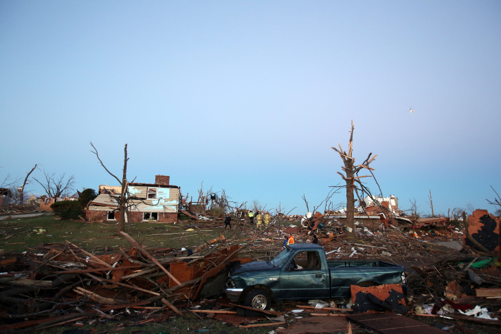 A firefighter searches through debris after a tornado struck on November 17, 2013 in Washington, Illinois. Several tornadoes touched down across the Midwest today with at least three people reported dead in Illinois. 