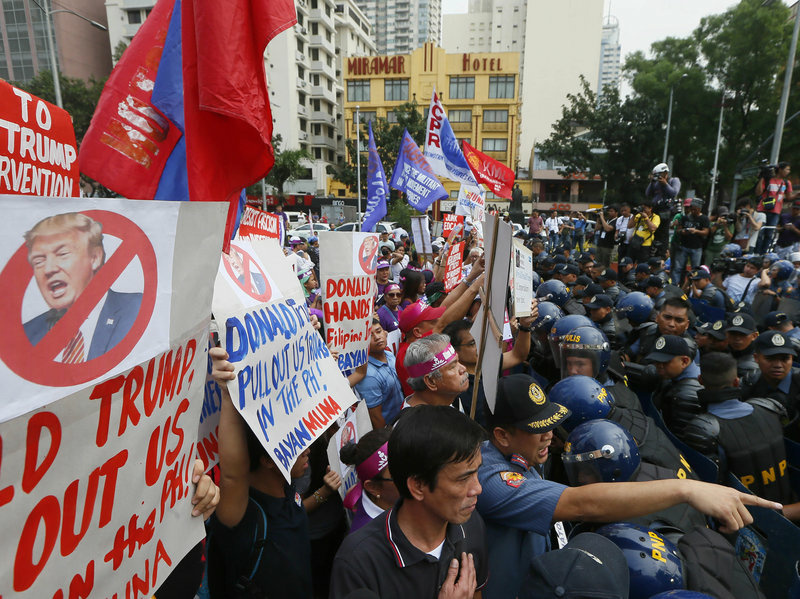 Protesters in Manila confront riot police as they try to march to the U.S. Embassy for a rally to coincide with the inauguration of President-elect Trump on Friday. Left-wing and Muslim activists have asked President Rodrigo Duterte to keep his promise of charting a foreign policy independent of the U.S. Protesters in Manila confront riot police as they try to march to the U.S. Embassy for a rally to coincide with the inauguration of President-elect Trump on Friday. Left-wing and Muslim activists have asked President Rodrigo Duterte to keep his promise of charting a foreign policy independent of the U.S.