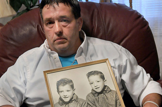 Gene Jones holds a mid-1960s photo of himself, right in photo, and his brother, Dean Jones. Gene's twin brother lost his life in the Upper Big Branch Coal Mine explosion.