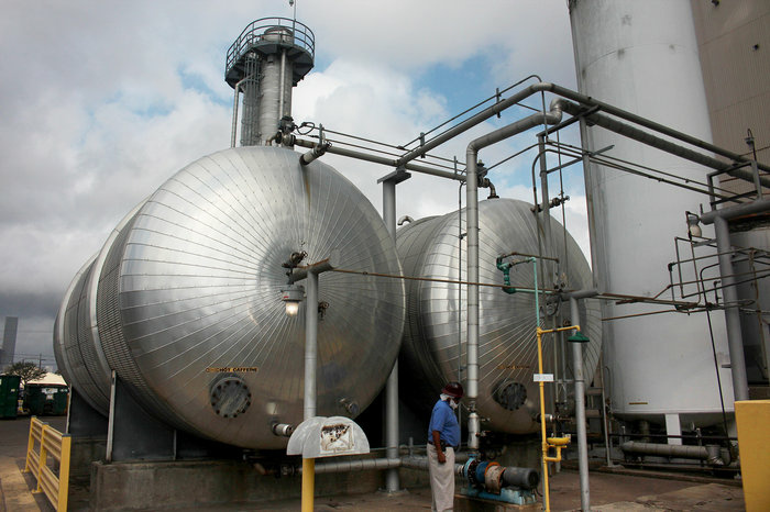 Boris Wheatley, a manager at Atlantic Coffee Solutions, inspects two tanks filled with a mixture of hot water and caffeine. The water will be evaporated to obtain crude caffeine powder. Boris Wheatley, a manager at Atlantic Coffee Solutions, inspects two tanks filled with a mixture of hot water and caffeine. The water will be evaporated to obtain crude caffeine powder.