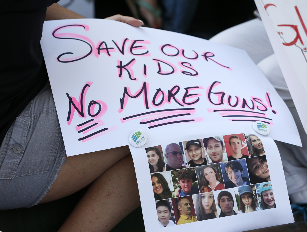 US-SCHOOL-SHOOTING-PROTEST Protesters hold signs at a gun control at the Broward County Federal Courthouse in Fort Lauderdale, Florida on February 17, 2018.