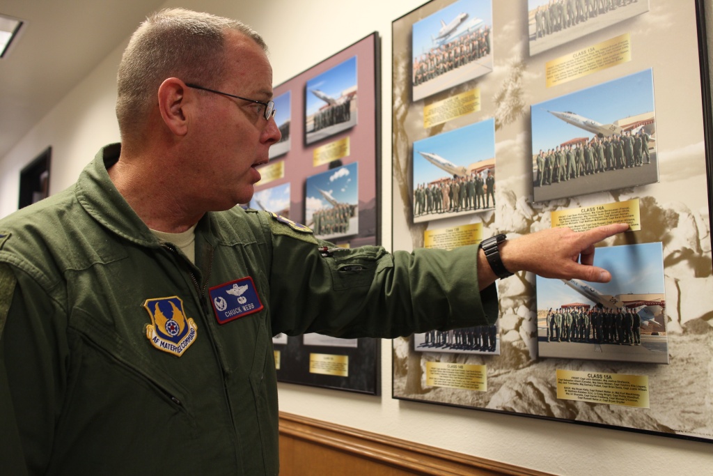 Test Pilot School Colonel Charles Webb walks down the hallways lined with class photos dating back to the school’s founding in 1944.