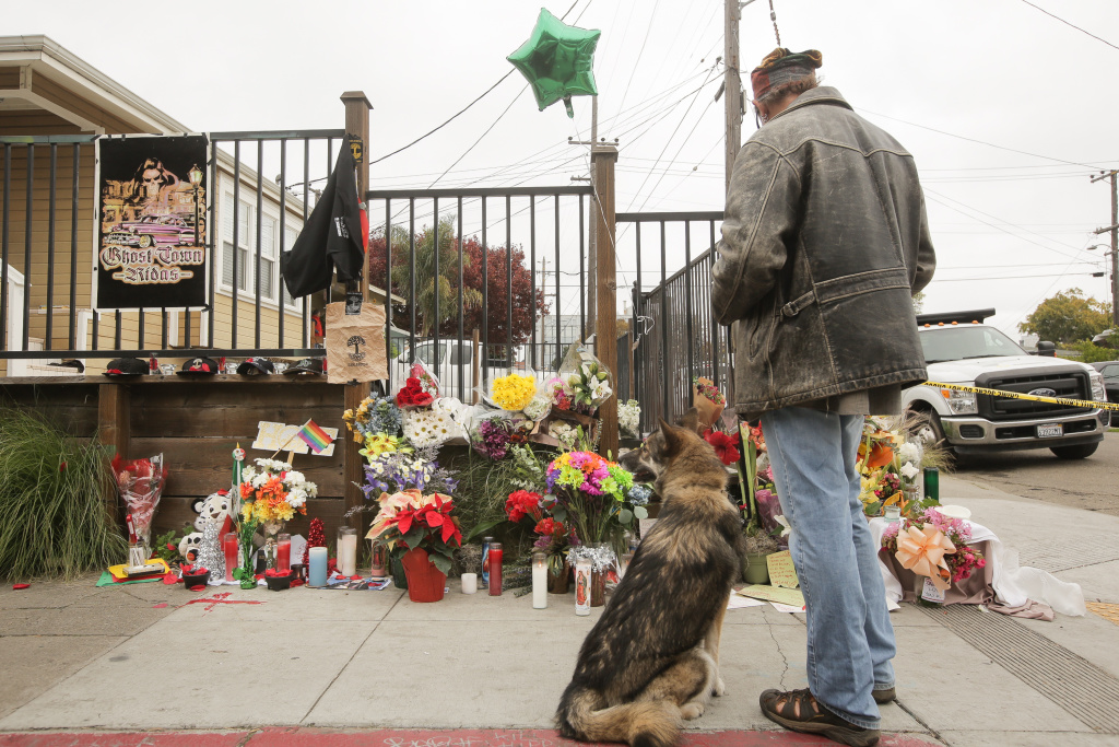 Dozens Dead in Oakland Warehouse Fire A man looks at a makeshift memorial near the site of a warehouse fire that has claimed the lives of at least thirty-six people on December 5, 2016 in Oakland, California. The fire took place during a musical event late Friday night.
