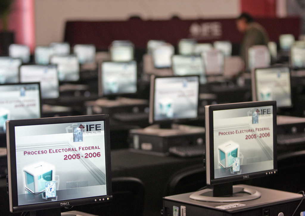 A technician (top-R) checks computers at A technician checks computers at the computer center of the Electoral Federal Institute in Mexico City.