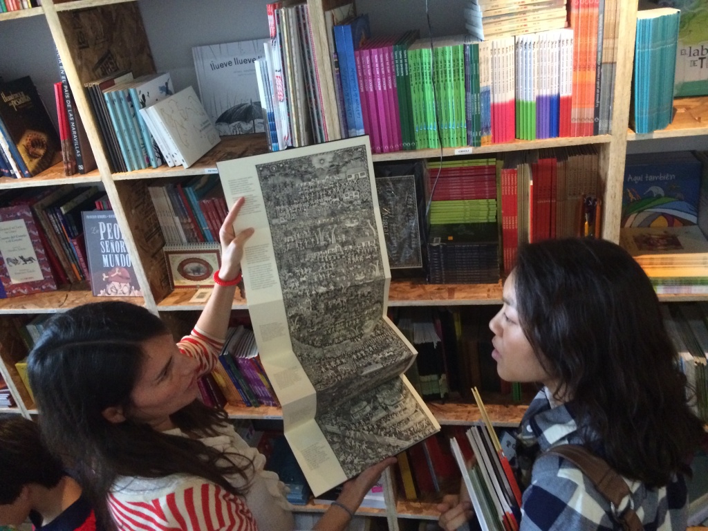 La Librería La Librería co-founder, Chiara Arroyo (left) shows a customer the children's book from Mexico called