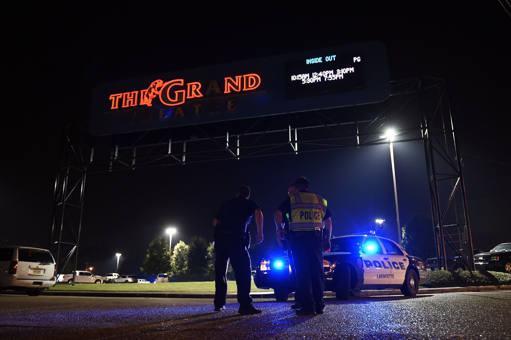 Movie theater shooting LAFAYETTE, LA - JULY 23: Lafayette police stand outside of the Grand Theater on July 23, 2015 in Lafayette, Louisiana. Three people are dead and seven more injured after a gunman opened fire inside the Grand Theatre. The gunman, whose identity is being withheld by police, is among the dead. (Photo by Stacy Revere/Getty Images)