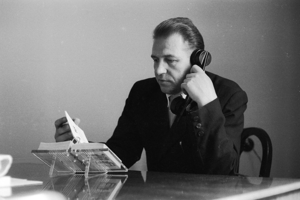 Desk Diary A man flips through his desk diary while talking on the telephone on May 18, 1961.