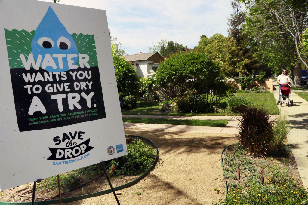 A sign encouraging people to save water is displayed at a news conference in Los Angeles. Water use restrictions in California amidst the state's ongoing drought have led to the phenomenon of A sign encouraging people to save water is displayed at a news conference in Los Angeles. Two new bills will help Californians save water even during wet times.