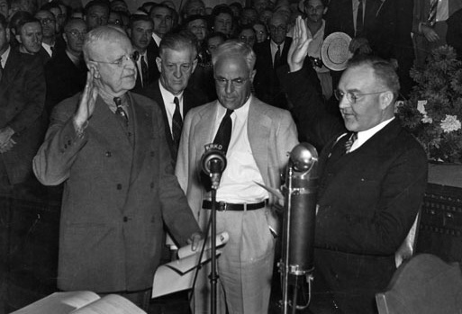 In a precedent setting ceremony, Judge Bowron is shown taking the oath of office in the City Council's chambers. This was the first time a mayor took office in a public ceremony and Bowron is the first mayor to be elected by means of a recall. Standing in front of the microphone from left to right: City Clerk Robert Dominguez, who is administering the oath; Council President Robert Burns, City Attorney Ray Chesebro, and Mayor Bowron.
In a precedent setting ceremony, Judge Bowron is shown taking the oath of office in the City Council's chambers. This was the first time a mayor took office in a public ceremony and Bowron is the first mayor to be elected by means of a recall. Standing in front of the microphone from left to right: City Clerk Robert Dominguez, who is administering the oath; Council President Robert Burns, City Attorney Ray Chesebro, and Mayor Bowron.