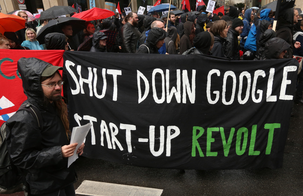 Berliners Protest Climbing Rent Prices Demonstrators carry a sign reading 'Shut Down Google,' in reference to the company's planned campus in the city, as tenants' rights organization representatives and activists protest against rent increases and gentrification, at Potsdamer Platz on April 14, 2018 in Berlin, Germany.