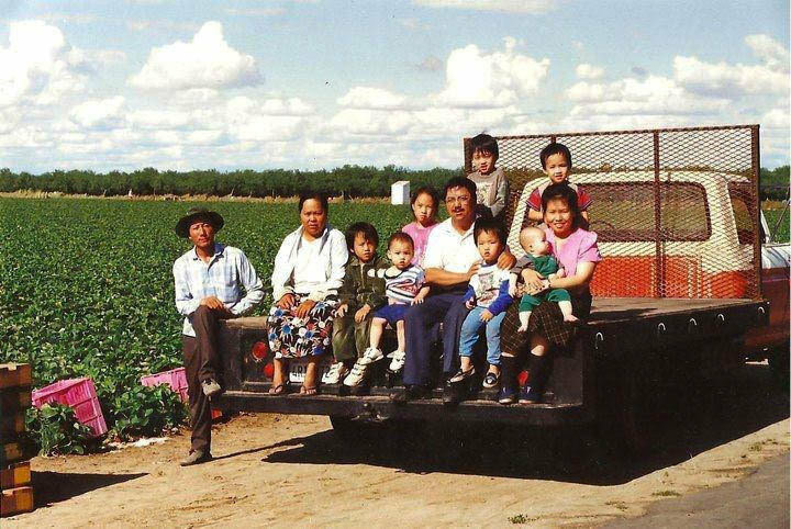 Asian Growers A family photo from the 1990s shows the Yang family sitting on a truck on their farm.