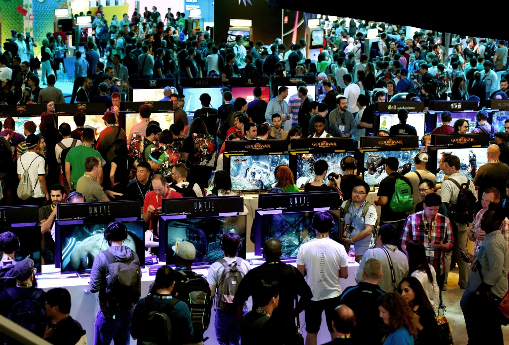 US-IT-INTERNET-GAMES-E3 Gamers test new video games on display at the Sony Playstation area on the opening day of the Electronic Entertainment Expo, known as E3 at the Convention Center in Los Angeles, California on June 16, 2015. Console kings Microsoft and Sony battled for players' hearts with blockbuster games and the lure of virtual worlds as the annual Electronic Entertainment Expo began in Los Angeles. AFP PHOTO / MARK RALSTON (Photo credit should read MARK RALSTON/AFP/Getty Images)