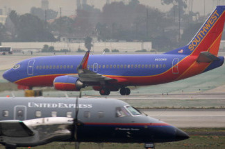 A Southwest airplane taxies as a United Express takes off at Los Angeles International Airport (LAX).