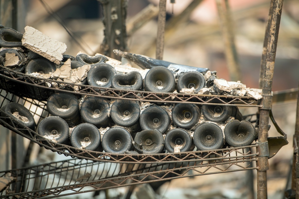 US-FIRE-CALIFORNIA Melted wine bottles are seen among the burned out remains of the Signorello Estate Winery in Napa, California on October 11, 2017.