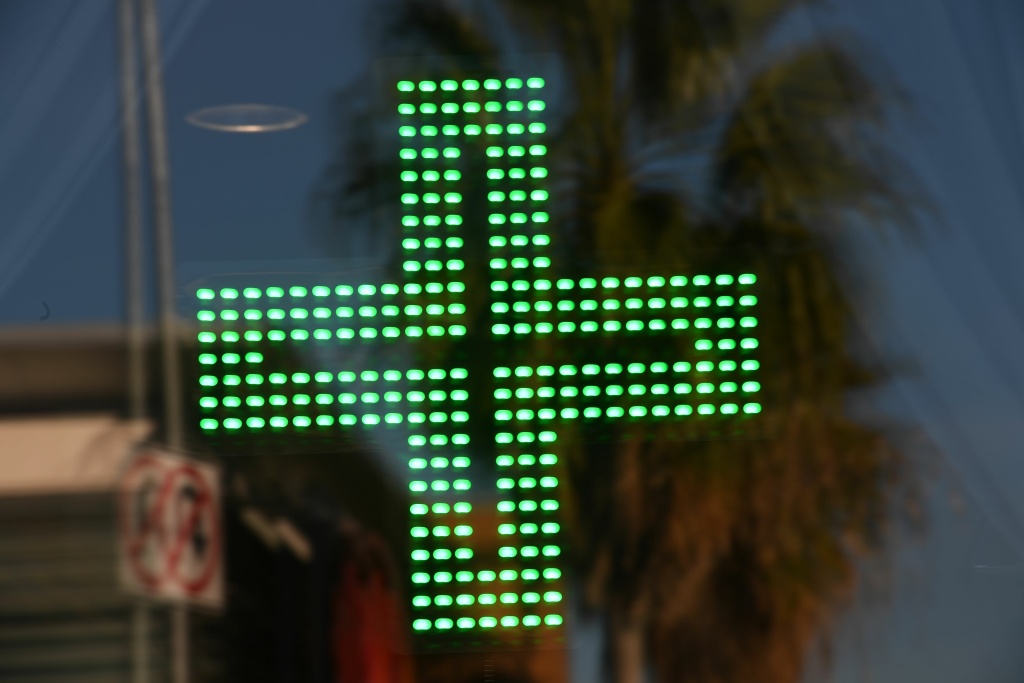 US-DRUGS-CANNABIS-CALIFORNIA A green cross indicating medical marijuana in the window at the Higher Path dispensary in the Sherman Oaks area of Los Angeles, California, December 27, 2017.