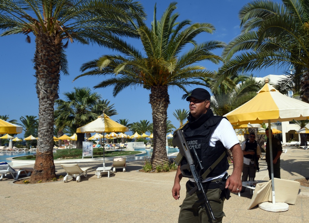 TUNISIA-UNREST-TOURISM A Tunisian security member stands next to a swimming pool at the resort town of Sousse, a popular tourist destination 140 kilometres (90 miles) south of the Tunisian capital, on June 26, 2015, following a shooting attack. At least 27 people, including foreigners, were killed in a mass shooting at a Tunisian beach resort packed with holidaymakers, in the North African country's worst attack in recent history.