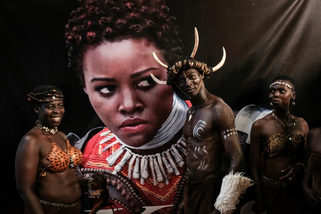 KENYA-MOVIE-BLACK PANTHER Dancers from Kenya's Luo tribe pose in front of an image of Kenyan actress Lupita Nyong'o before the African premier of