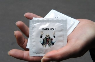 Mercer 12221 A woman shows condoms with a picture of Pope Benedict XVI and reading 'I said No !'. The condoms were released to mock Pope Benedict XVI after he rejected condoms as a weapon against AIDS during his African trip.