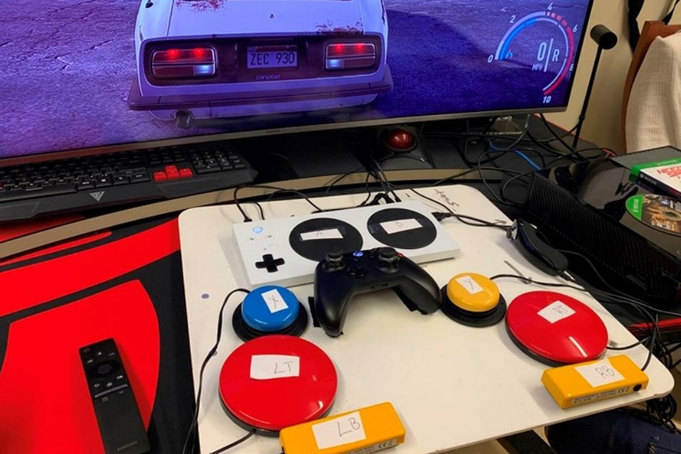 American Homefront VA Vets The white rectangular Xbox adaptive controller can be paired with attachments such as the colored buttons to assist people with a variety of injuries.