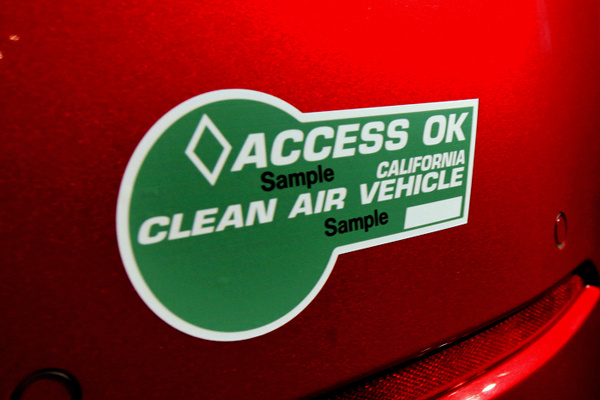 Green stickers are offered to low-emission cars on a limited basis. Vehicles that run entirely on alternative fuel sources, such as fully electric cars, can be given white stickers. There's no limit on the number of white stickers given out by the Department of Motor Vehicles, but only 55,000 green stickers are on the road at any time.