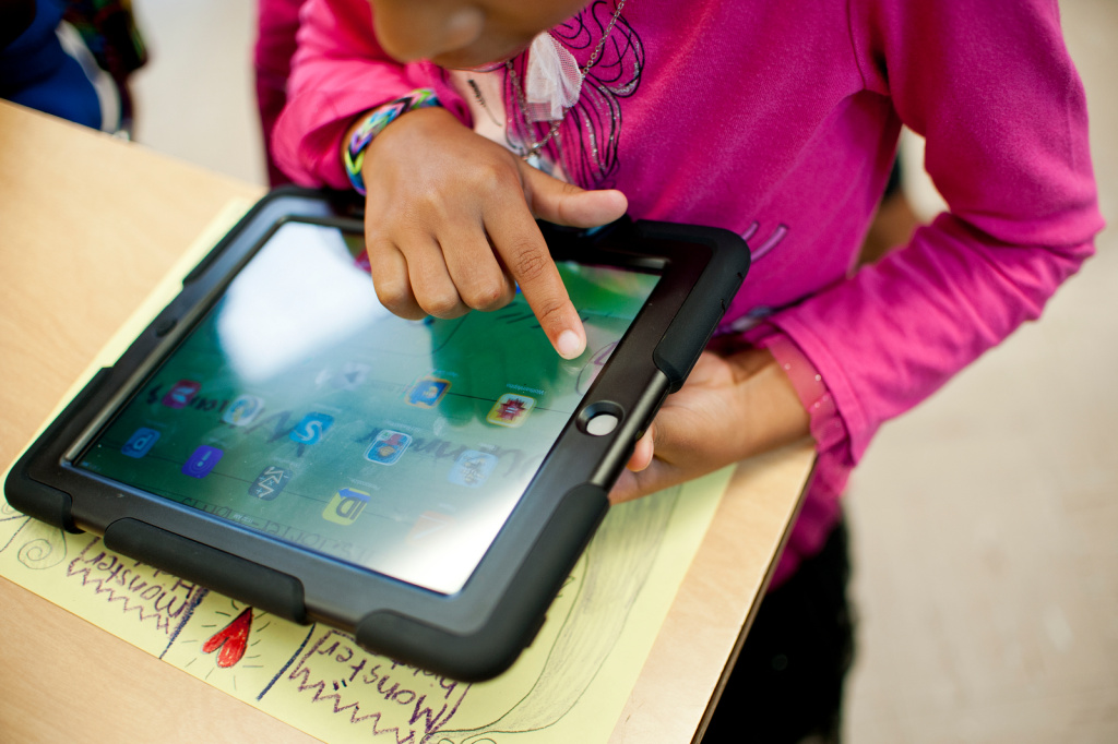 L.A. Unified has already purchased 75,000 iPads, half with Pearson software. Here, second graders at Baldwin Hills Elementary swipe through their iPads for the first time and call out the apps they see. 