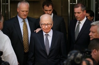 Mercer 19579 News Corp. Chairman Rupert Murdoch (C) looks down as he leaves the One Aldwych Hotel surrounded by his personal security team on in London, England.