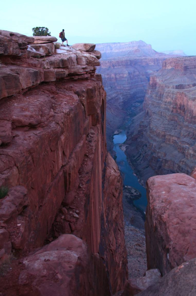 A hiker gazes 3,000 feet down to the Colorado River at Toroweap Overlook in Grand Canyon National Park. A parks advocacy group says the Grand Canyon region has lost 120,000 visitors and $11 million in visitor spending since the government shutdown began. A hiker gazes 3,000 feet down to the Colorado River at Toroweap Overlook in Grand Canyon National Park.