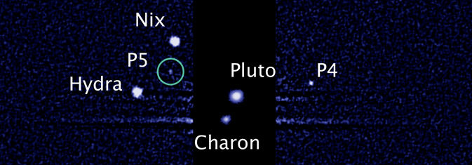 This image, taken by NASA's Hubble Space Telescope, shows five moons orbiting the distant, icy dwarf planet Pluto. The green circle marks the newly discovered moon, designated P5, as photographed by Hubble's Wide Field Camera 3 on July 7.