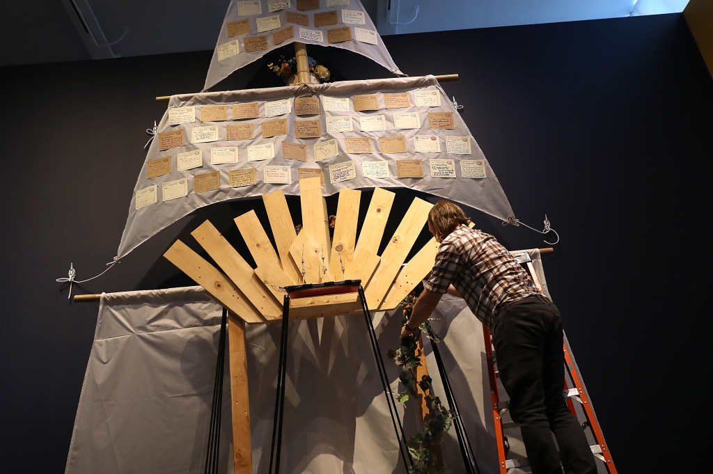 Installation Of Memorial Honors Victims Of Ghost Ship Fire In Oakland Artist Peter Foucaulton works on his