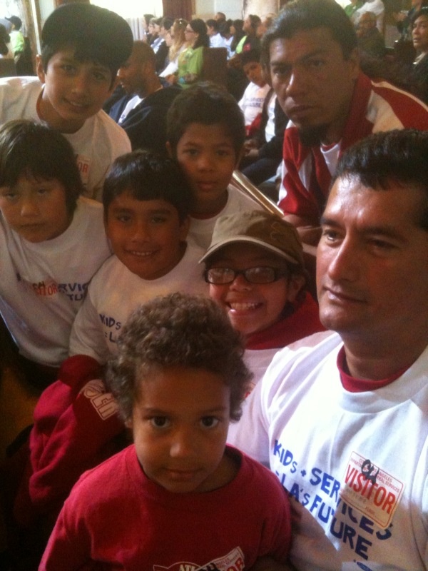 Jazlyn Landeverde, 10, sits smiling in the middle of her Stoner Park soccer team at Los Angeles City Hall, where she and her teammates were protesting cuts to the city's Recreation and Parks Department.