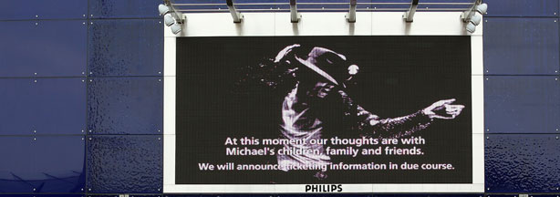 LONDON, ENGLAND - JUNE 26: Fans gather to lay tributes to Michael Jackson outside the O2 Arena where Jackson was to perform 50 sell out nights starting next month on June 26, 2009 in London, England. The 50-year old child star was reportedly found not breathing at his LA home and was rushed to UCLA Medical Center hospital, where he was later pronounced dead apparently from a heart attack.