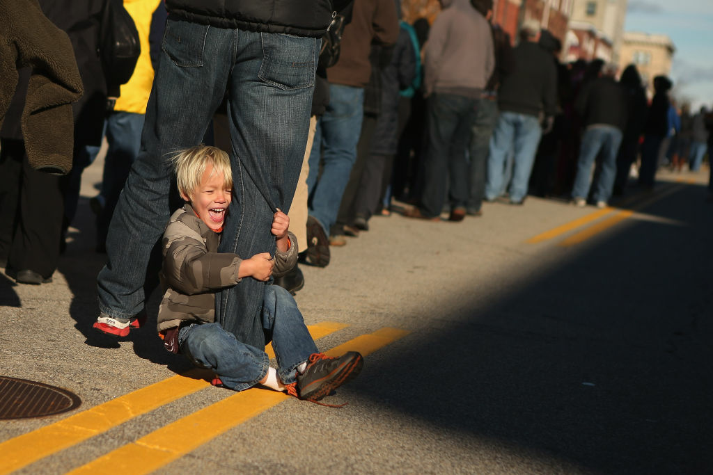 President Obama Continues His Push Through Key Swing States In Final Days Before Election Hudson Schoewe, 4, of Cape Elizabeth, Maine, rides on his father's leg while waiting in line with more than 14,000 people to attend a campaign rally with U.S. President Barack Obama in State Capitol Square November 4, 2012 in Concord, New Hampshire.