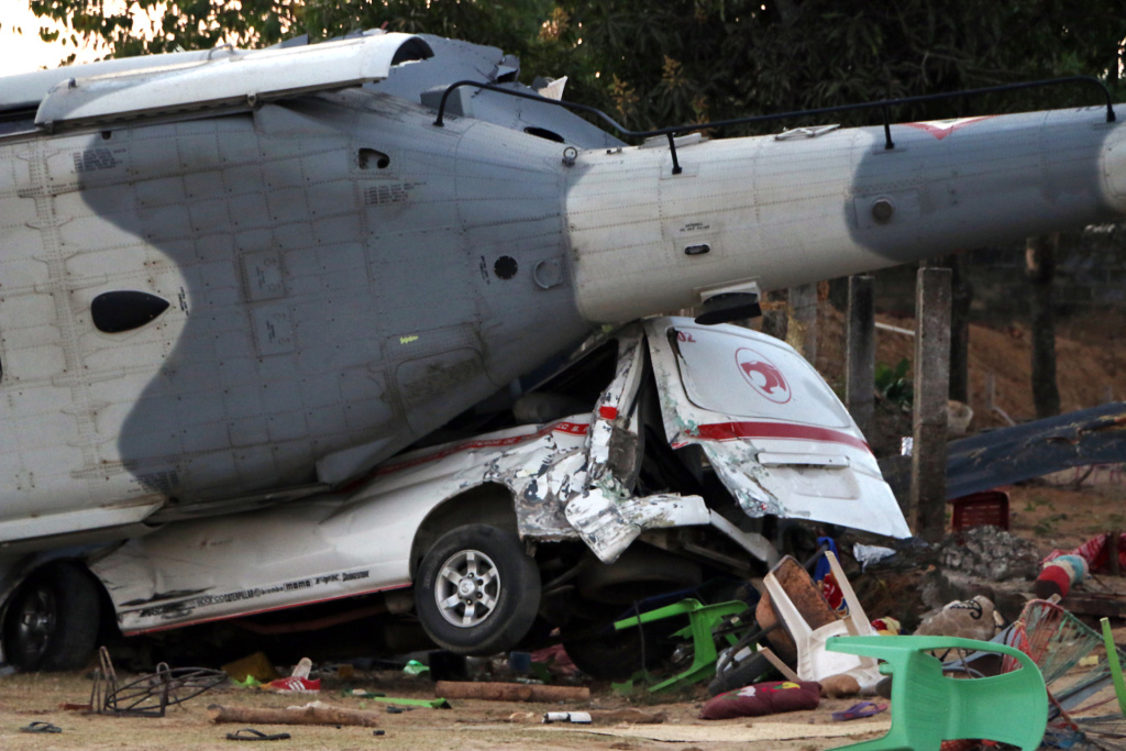 MEXICO-QUAKE The remains of the military helicopter lay where it fell on a van in Santiago Jamiltepec, Oaxaca, Mexico, on February 17, 2018. A 7.2-magnitude earthquake rattled Mexico, causing little damage but triggering a tragedy when a minister's helicopter crash-landed on the way to the epicenter, killing 13 people, including three children, on the ground.