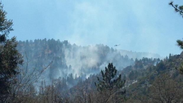 Helicopters assist in fighting the Sharp Fire burning near Wrightwood, Calif.