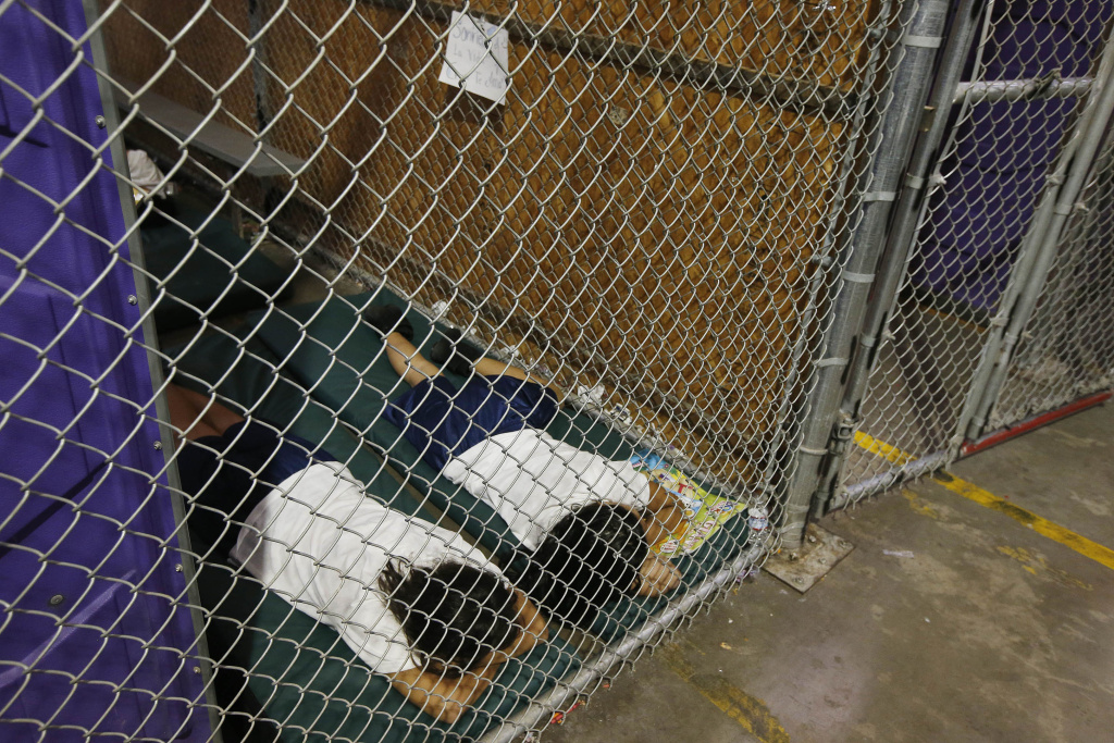 Familes and Children Held In U.S. Customs and Border Protection Processing Facility Two female detainees sleep in a holding cell, as the children are separated by age group and gender, as hundreds of mostly Central American immigrant children are being processed and held at the U.S. Customs and Border Protection Nogales Placement Center on June 18, 2014, in Nogales, Arizona. Brownsville, Texas, and Nogales, have been central to processing the more than 47,000 unaccompanied children who have entered the country illegally since Oct. 1.