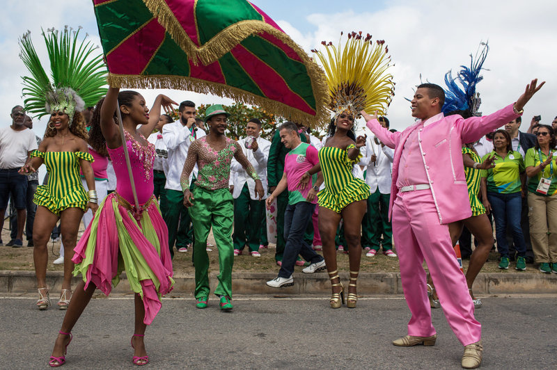 gettyimages-585566984_custom-f310fd48aef4e1e306b30b8cc3c3ce31e05733a2-s800-c85.jpg Dancers from the Mangueira samba school perform in the street Thursday while waiting for the arrival of the Olympic flame ahead of the games, which open Friday in Rio de Janeiro. The flame will be carried through the streets of Rio to Maracana Stadium for Friday night's opening ceremony.