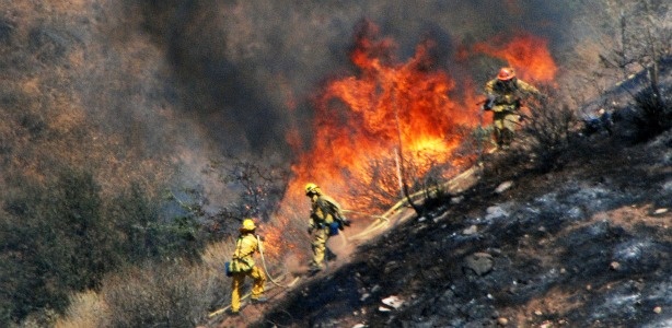 Firefighters try to catch a hot spot from a wildfire in Agua Dulce, Calif., Monday, Sept. 5, 2011. The fire was burning near the Vasquez Rocks county park, whose other-worldly, slanting rock monoliths have served as the backdrop for many Hollywood film and TV shows including "Star Trek."