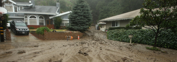 Mercer 2593 Mud flows between houses and into the street in an evacuated neighborhood during the fourth storm of the week on January 21, 2010 in La Canada Flintridge, California.