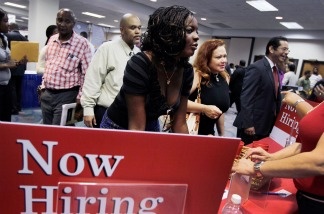Mercer 20707 Ida Aka speaks with a job recruiter from Bank of America at a job fair in the James L. Knight Center on August 23, 2011 in Miami, Florida.