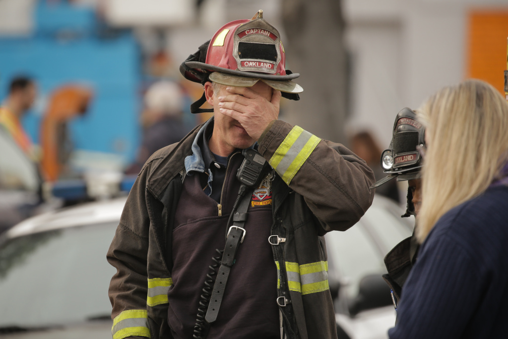 Dozens Feared Dead In Oakland Warehouse Fire OAKLAND, CA - DECEMBER 05: Oakland fire captain Chris Foley wipes his brow at the site of a warehouse fire that has claimed the lives of at least thirty-six people on December 5, 2016 in Oakland, California. The fire took place during a musical event late Friday night. (Photo by Elijah Nouvelage/Getty Images)