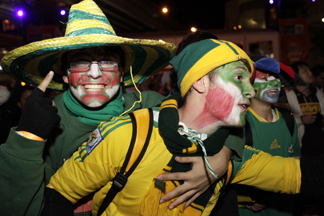 In this handout photo provided by Rick Stevens, Mexican and South African football fans celebrate the opening match of the 2010 World Cup between South Africa and Mexico at the Sydney International FIFA Fan Fest opening ceremony on June 11, 2010 in Sydney, Australia.
