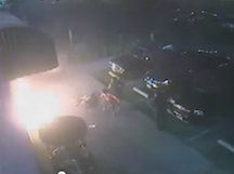 An image from a video showing a man who was burned when someone threw a fire bomb at him outside of a Long Beach market.