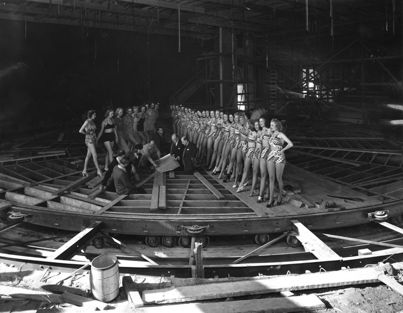 This photo shows Earl Carroll, some of his aides and chorus girls examining the theater's unique moving stage in 1938. This photo shows Earl Carroll, some of his aides and chorus girls examining the theater's unique moving stage in 1938.