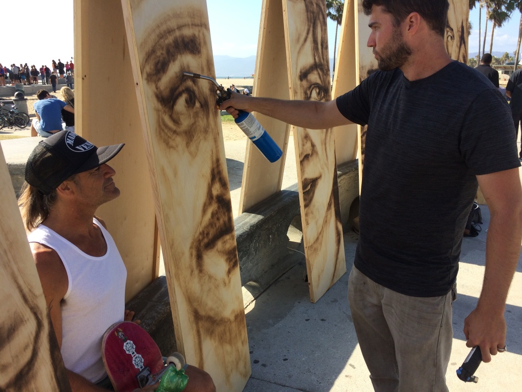Paul Anthony Ruiz, a long time Venice resident and skater, gets his portrait done by Aronson. Paul Anthony Ruiz, a long time Venice resident and skater, gets his portrait done by Aronson.