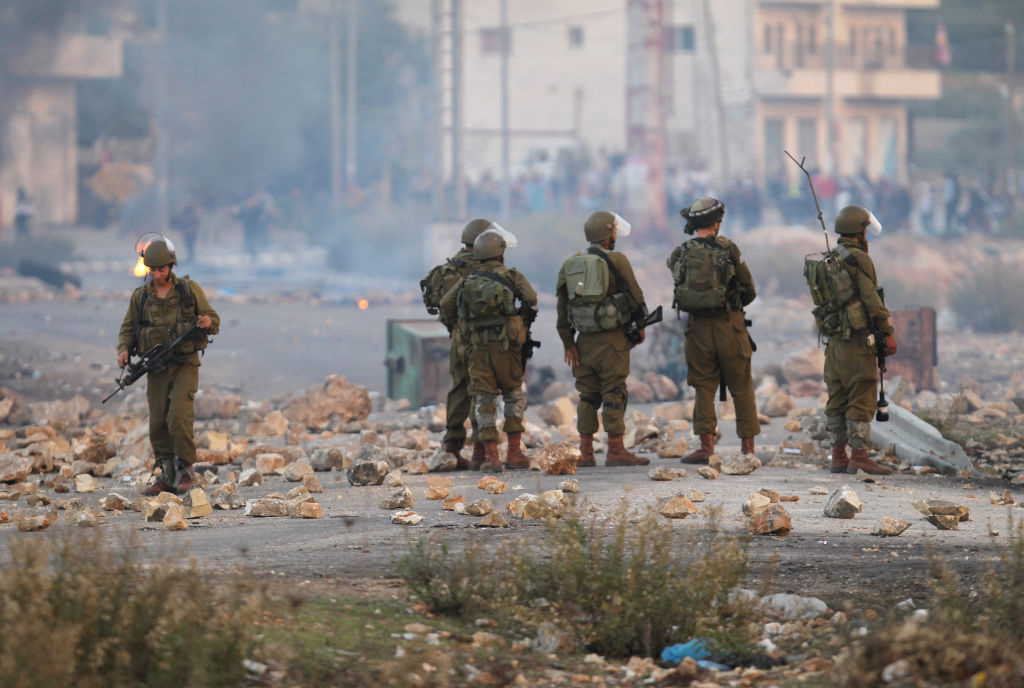 PALESTINIAN-ISRAEL-GAZA-DEMO-UNREST Israeli soldiers clash with Palestinian students from Birzeit University for the second consecutive day as they protest against the ongoing Israeli offensive on the Gaza Strip in the West Bank town of Betunia on November 18, 2012. Israel's Foreign Minister Avigdor Lieberman said that Israel would not negotiate a truce with Gaza Strip's Hamas rulers as long as rocket fire continues from the Palestinian enclave.