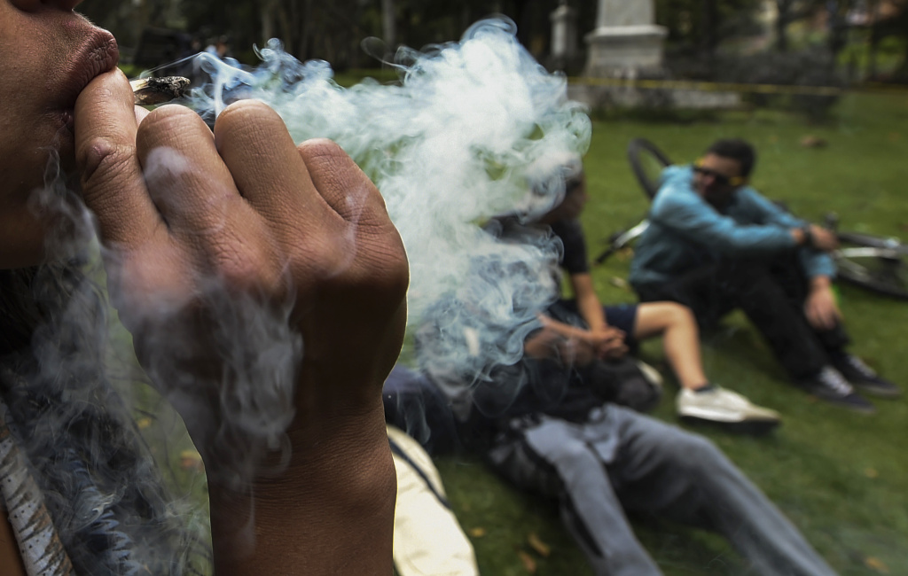 COLOMBIA-MARIJUANA-PROTEST An activist in Bogota, Colombia rolls a joint under the motto