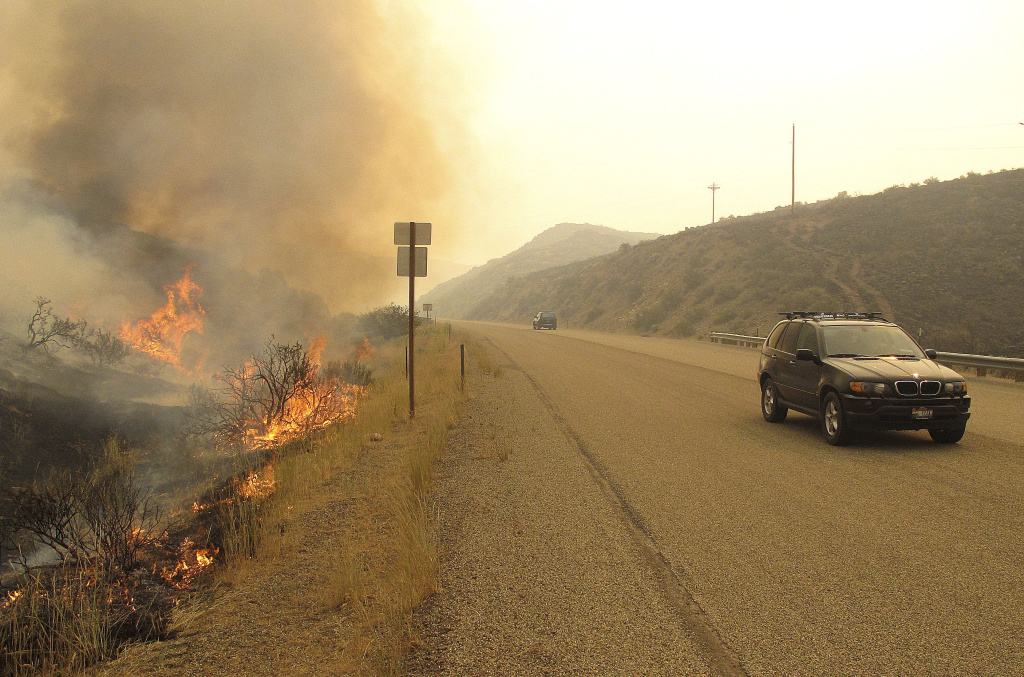 Idaho Wildfires A fire burns on the shoulder of U.S. Highway 20 north of Mountain Home, Idaho on Monday, Aug. 12, 2013. The blaze was among several touched off in recent days by a lightning storm that rolled through the region. The largest two fires, the Pony Complex and Elk Complex, had burned more than 300 square miles of sagebrush, grass and pine trees and forced the evacuation of small, remote towns in the region.