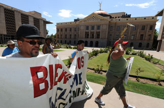 File photo: Protesters march past the Arizona State Capital Building as they campaign against the controversial state law SB1070 which criminalizes illegal immigration, two days before it takes effect, in Phoenix on July 27, 2010.